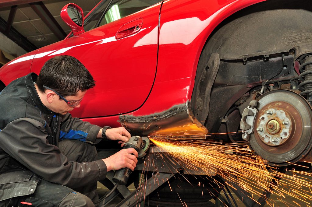 Auto body worker repairing 